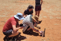 Here I show guests at NamibRand, how my data loggers record soil moisture